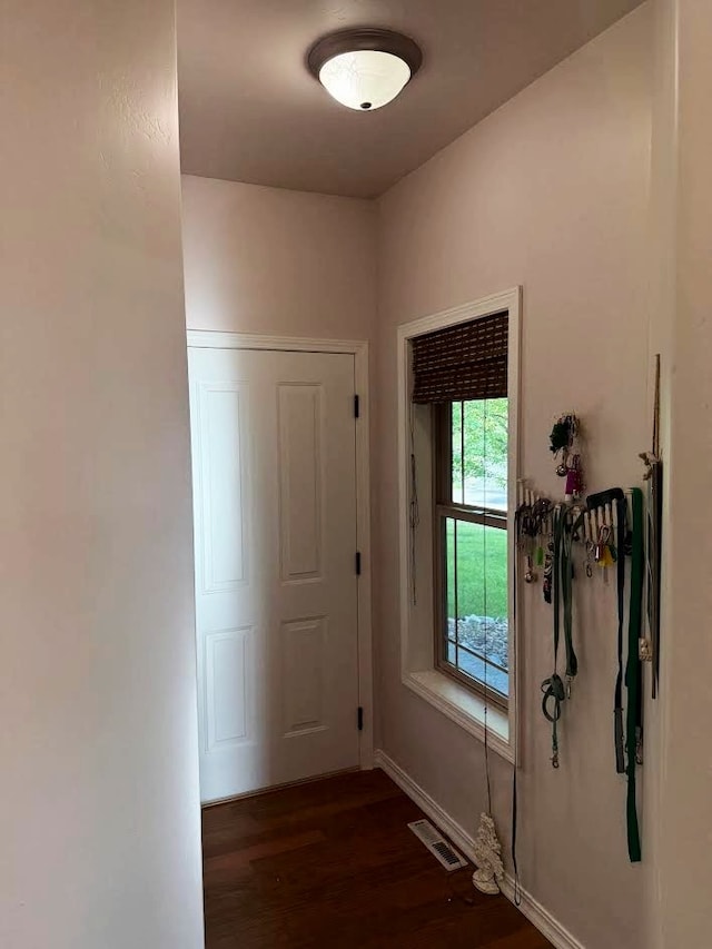 151 Whisper Ridge Dr, Bigfork, MT 59911 - doorway with dark wood-style floors and baseboards