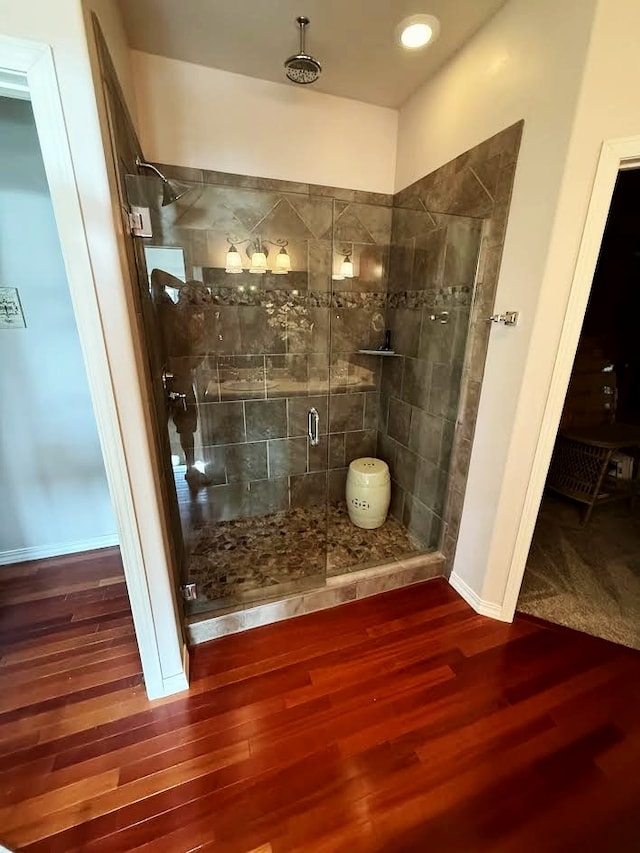 151 Whisper Ridge Dr, Bigfork, MT 59911 - full bathroom featuring a shower stall and wood finished floors