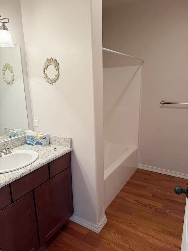 151 Whisper Ridge Dr, Bigfork, MT 59911 - full bath featuring wood finished floors, vanity, and  shower combination