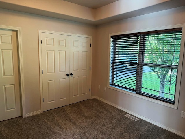 151 Whisper Ridge Dr, Bigfork, MT 59911 - unfurnished bedroom featuring carpet and a closet