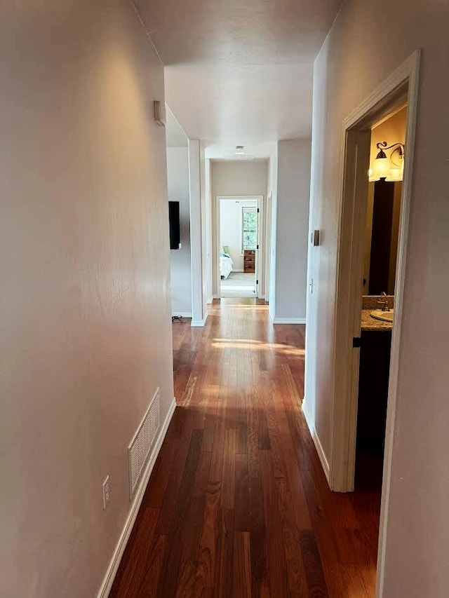 151 Whisper Ridge Dr, Bigfork, MT 59911 - corridor featuring dark wood-style flooring and baseboards