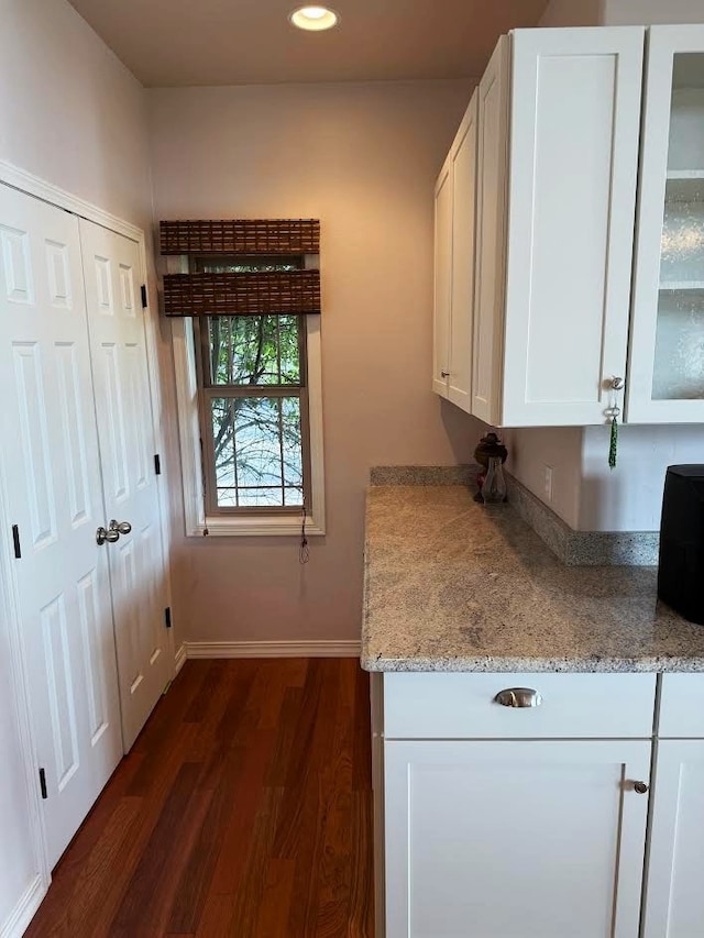 151 Whisper Ridge Dr, Bigfork, MT 59911 - kitchen featuring dark wood-style floors, white cabinets, glass insert cabinets, recessed lighting, and light stone countertops