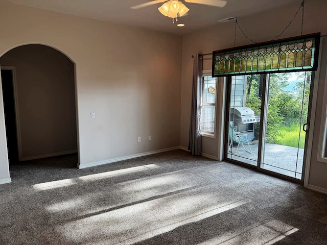 151 Whisper Ridge Dr, Bigfork, MT 59911 - empty room with a ceiling fan, arched walkways, and carpet flooring