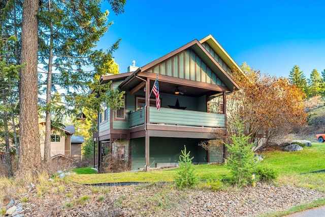 151 Whisper Ridge Dr, Bigfork, MT 59911 - view of front of house with board and batten siding and a front lawn