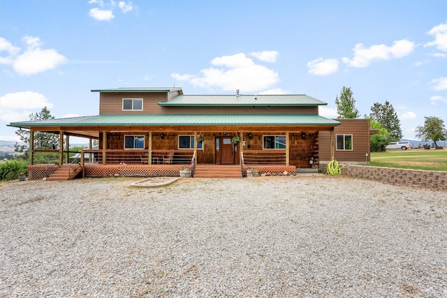 674 Porter Hill Rd, Stevensville, MT 59870 - view of front of property with covered porch, gravel driveway, and a metal roof