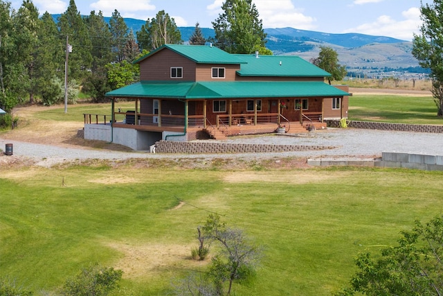 674 Porter Hill Rd, Stevensville, MT 59870 - rear view of house featuring covered porch, a mountain view, a yard, and a metal roof