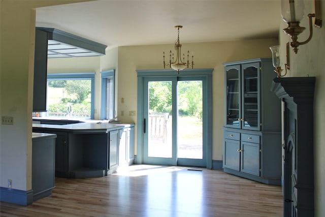 11740 Gopher Dr, Missoula, MT 59808 - unfurnished dining area featuring light wood finished floors, healthy amount of natural light, and a chandelier