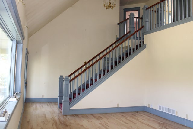 11740 Gopher Dr, Missoula, MT 59808 - stairway with wood finished floors, a chandelier, and a towering ceiling