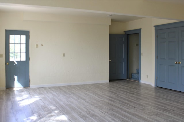 11740 Gopher Dr, Missoula, MT 59808 - unfurnished living room with wood finished floors and stairway