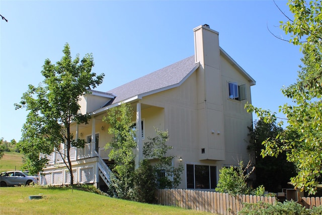 11740 Gopher Dr, Missoula, MT 59808 - view of side of home featuring a shingled roof and a chimney