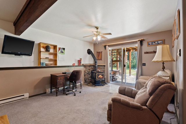 670 Potter Creek Rd, Olney, MT 59927 - home office with a wood stove, ceiling fan, a baseboard heating unit, carpet flooring, and a baseboard radiator