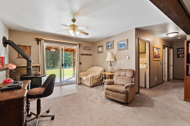 670 Potter Creek Rd, Olney, MT 59927 - home office featuring a ceiling fan, a wood stove, light carpet, and washer / clothes dryer