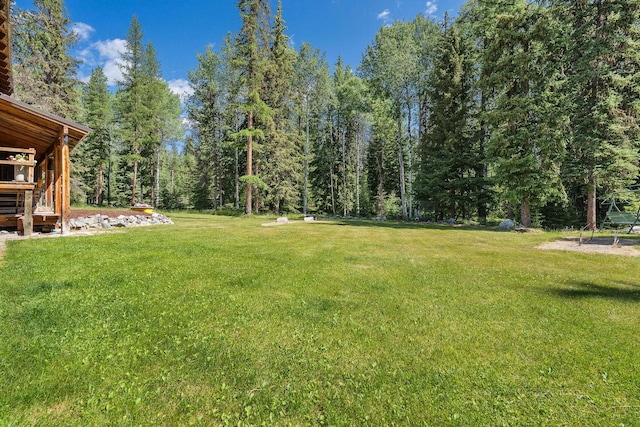 670 Potter Creek Rd, Olney, MT 59927 - view of grassy yard featuring a forest view