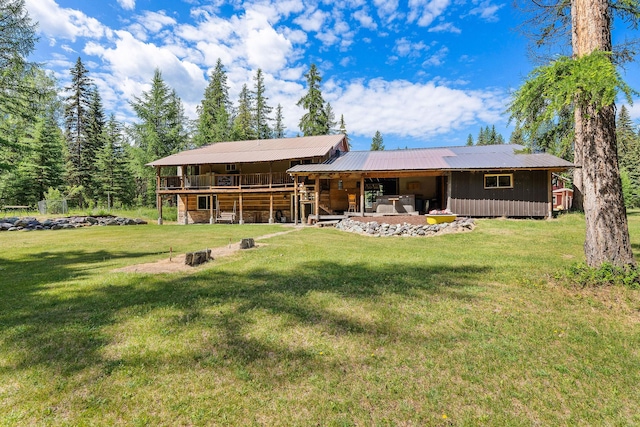 670 Potter Creek Rd, Olney, MT 59927 - rear view of house with a lawn, a metal roof, and a wooden deck