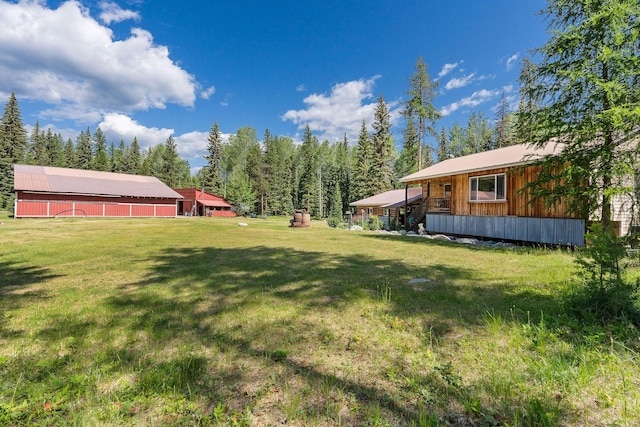 670 Potter Creek Rd, Olney, MT 59927 - view of green lawn featuring an outbuilding and a barn