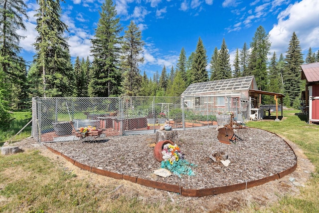 670 Potter Creek Rd, Olney, MT 59927 - view of green lawn featuring a greenhouse and an outdoor structure