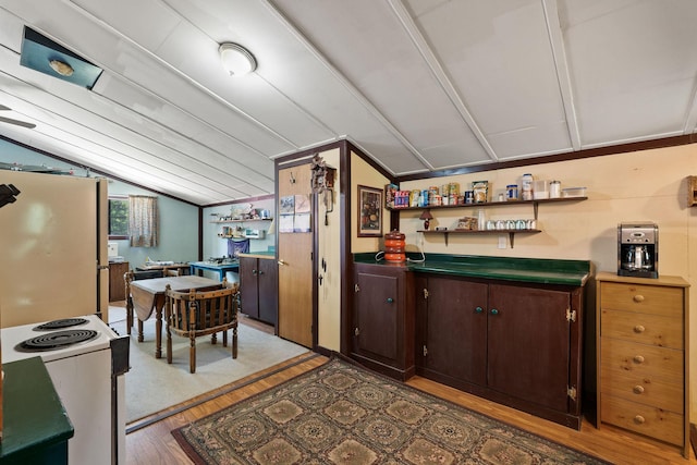 670 Potter Creek Rd, Olney, MT 59927 - kitchen with lofted ceiling, white appliances, wood finished floors, dark brown cabinetry, and open shelves