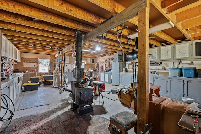 670 Potter Creek Rd, Olney, MT 59927 - below grade area with a wood stove and washer and clothes dryer