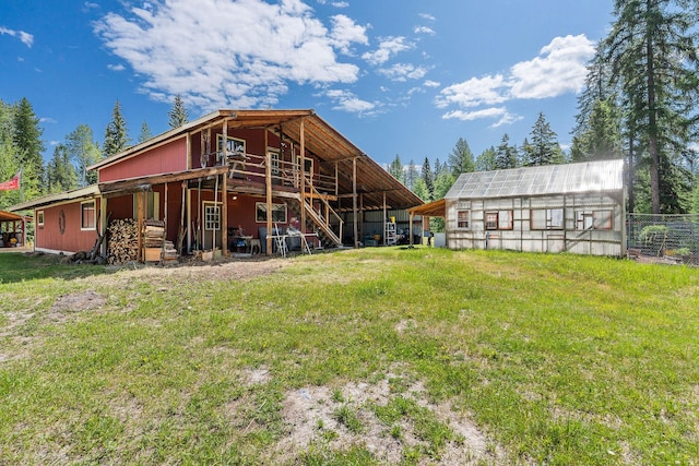 670 Potter Creek Rd, Olney, MT 59927 - rear view of property featuring a greenhouse, an outdoor structure, and a deck