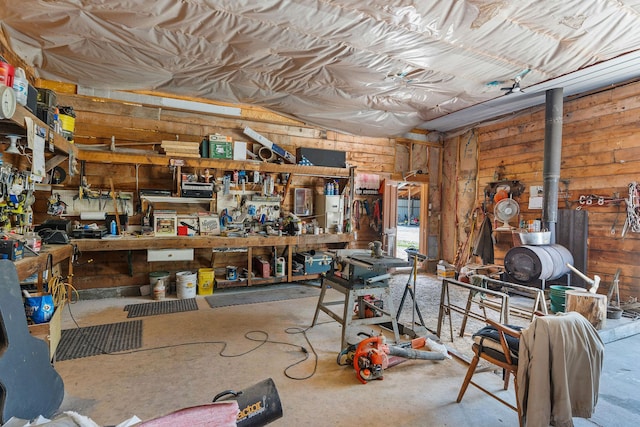 670 Potter Creek Rd, Olney, MT 59927 - garage with a workshop area, wood walls, and a wood stove