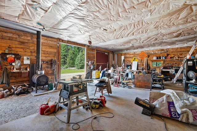670 Potter Creek Rd, Olney, MT 59927 - garage with a wood stove and wooden walls