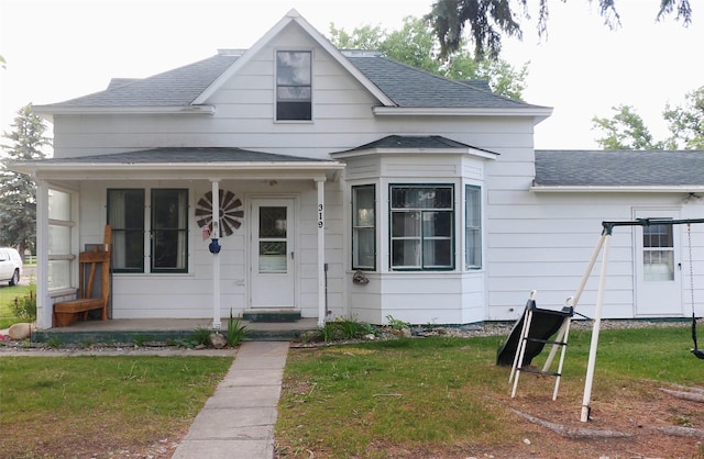 319 2nd St SW, Choteau, MT 59422 - view of front of house featuring roof with shingles and a front lawn