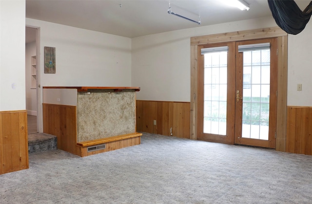 319 2nd St SW, Choteau, MT 59422 - carpeted spare room featuring wainscoting and wooden walls