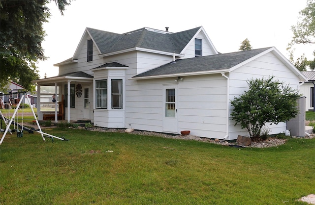 319 2nd St SW, Choteau, MT 59422 - back of house featuring roof with shingles and a yard