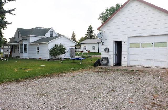 319 2nd St SW, Choteau, MT 59422 - view of side of property featuring a garage and a yard