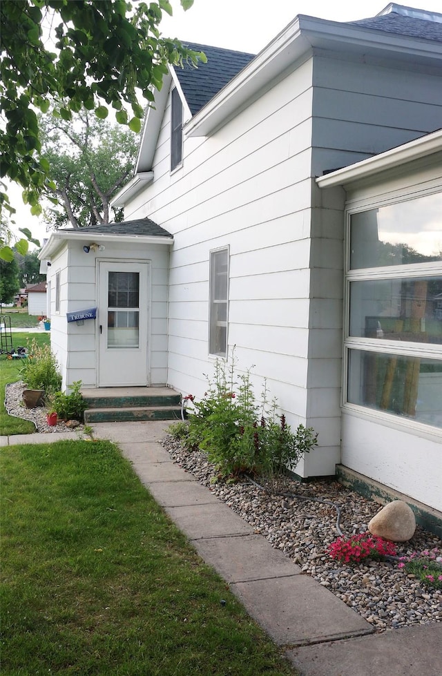 319 2nd St SW, Choteau, MT 59422 - property entrance featuring roof with shingles and a yard