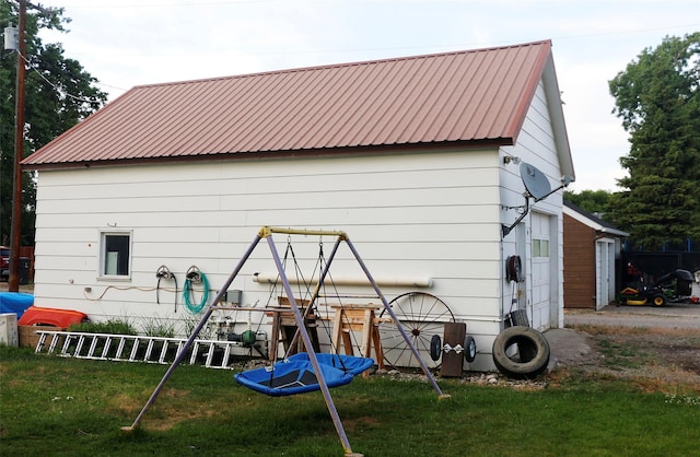 319 2nd St SW, Choteau, MT 59422 - rear view of property featuring a metal roof and a lawn
