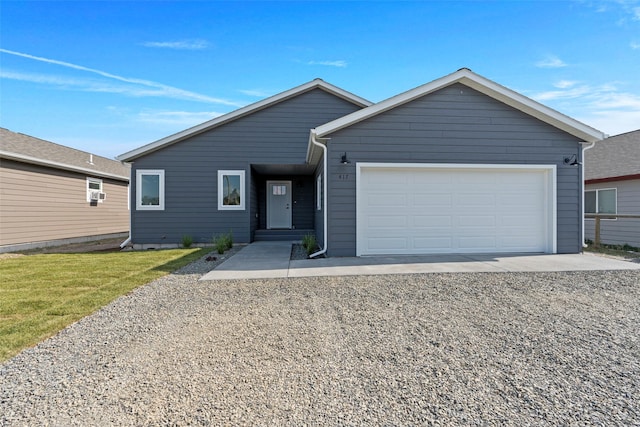 417 I St, Townsend, MT 59644 - view of front of house featuring a garage, gravel driveway, and a front lawn