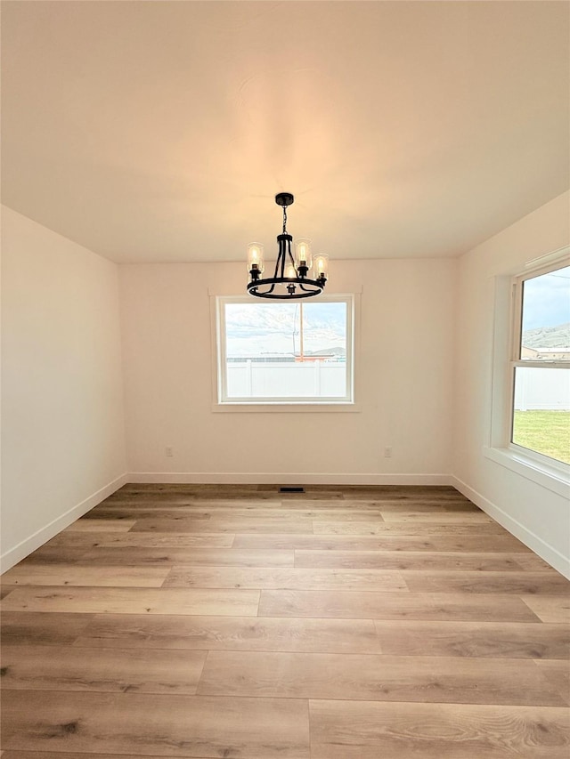 417 I St, Townsend, MT 59644 - empty room with a chandelier and light wood-style floors