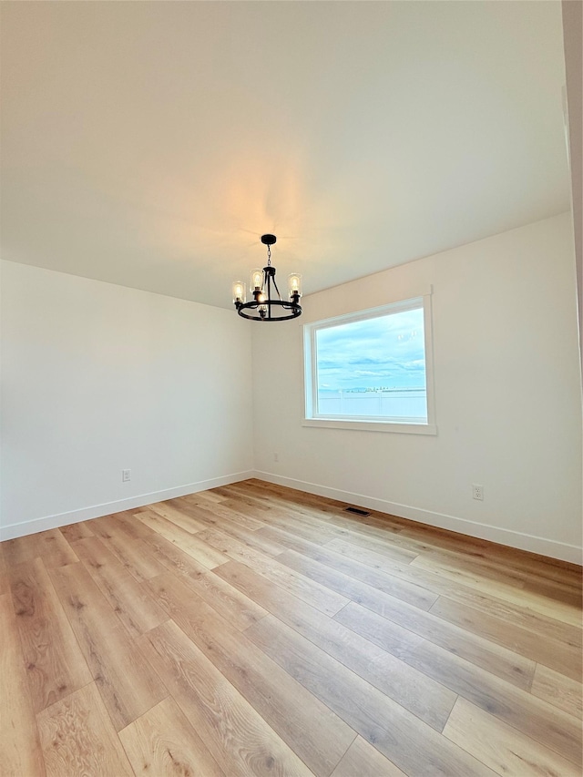 417 I St, Townsend, MT 59644 - spare room featuring a chandelier and light wood-style flooring