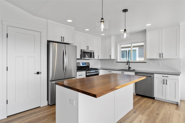417 I St, Townsend, MT 59644 - kitchen featuring stainless steel appliances, butcher block counters, recessed lighting, white cabinets, and decorative backsplash