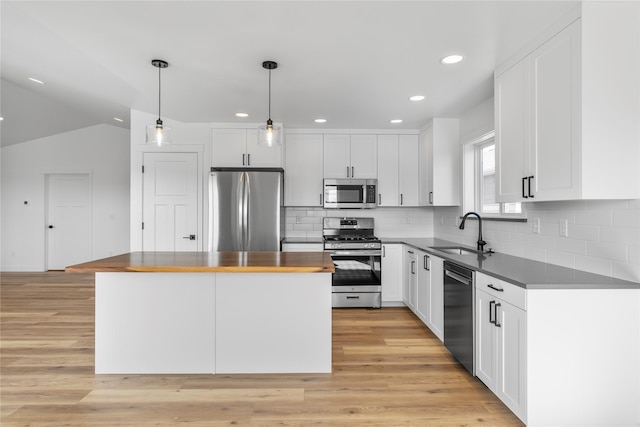 417 I St, Townsend, MT 59644 - kitchen with appliances with stainless steel finishes, white cabinets, a center island, tasteful backsplash, and recessed lighting