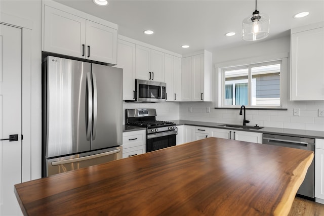 417 I St, Townsend, MT 59644 - kitchen with stainless steel appliances, butcher block countertops, backsplash, white cabinetry, and recessed lighting