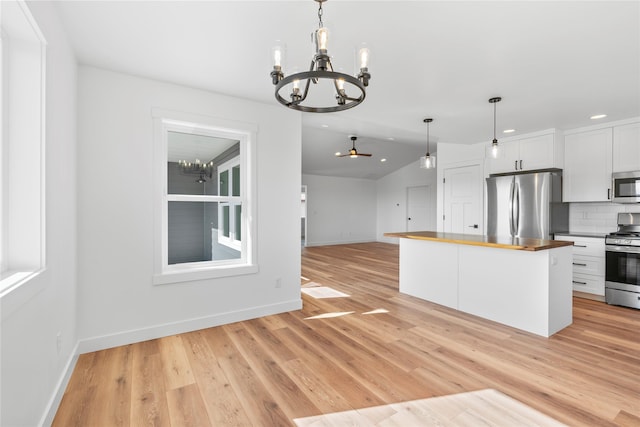 417 I St, Townsend, MT 59644 - kitchen featuring appliances with stainless steel finishes, a chandelier, recessed lighting, white cabinets, and tasteful backsplash