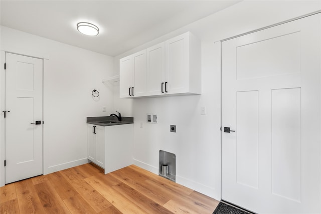 417 I St, Townsend, MT 59644 - laundry room featuring washer hookup, light wood-type flooring, hookup for an electric dryer, and cabinet space