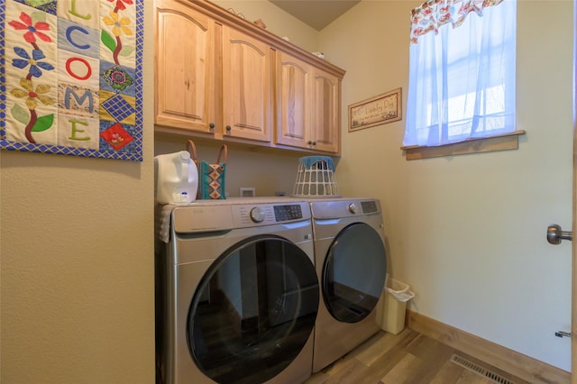 10487 Coulter Pine St, Lolo, MT 59847 - laundry room with cabinet space, washer and clothes dryer, and wood finished floors