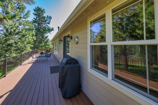 10487 Coulter Pine St, Lolo, MT 59847 - wooden terrace with outdoor dining space and a grill