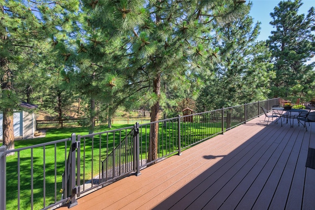 10487 Coulter Pine St, Lolo, MT 59847 - wooden terrace with a lawn and outdoor dining space
