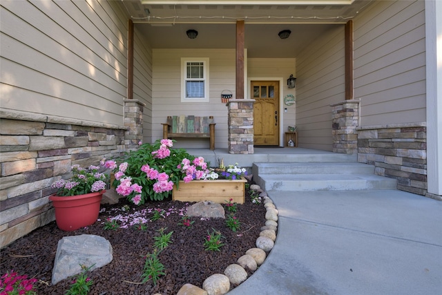 10487 Coulter Pine St, Lolo, MT 59847 - entrance to property featuring stone siding and a porch