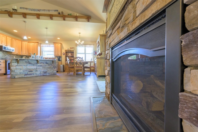 10487 Coulter Pine St, Lolo, MT 59847 - living room featuring wood finished floors, a chandelier, recessed lighting, and a stone fireplace