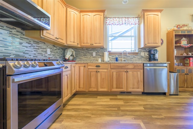 10487 Coulter Pine St, Lolo, MT 59847 - kitchen featuring appliances with stainless steel finishes, light brown cabinets, and light stone counters