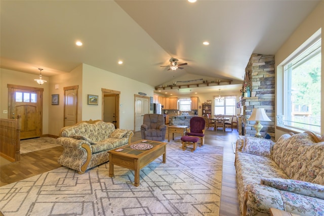 10487 Coulter Pine St, Lolo, MT 59847 - living area with vaulted ceiling, light wood-type flooring, ceiling fan, a chandelier, and recessed lighting