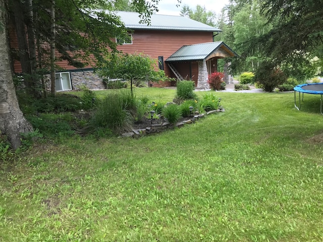 110 Lone Cedar Ln, Columbia Falls, MT 59912 - view of green lawn with a trampoline