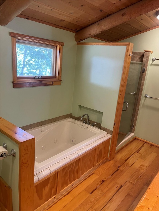 22550 Hill Rd, Clinton, MT 59825 - bathroom with a wooden ceiling with exposed beams, wood finished floors, a shower stall, and a whirlpool tub