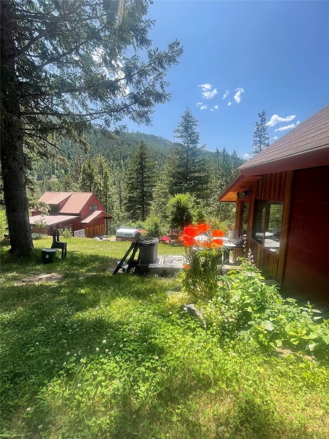 22550 Hill Rd, Clinton, MT 59825 - view of grassy yard featuring a forest view