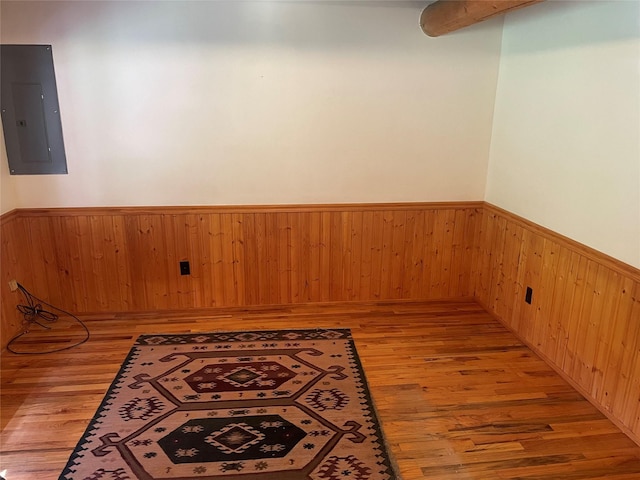 22550 Hill Rd, Clinton, MT 59825 - unfurnished room featuring electric panel, wainscoting, light wood-type flooring, and wood walls